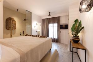 a hotel room with a bed and a large mirror at Athina Studios and Suites Plaka in Plaka