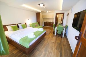 a bedroom with a bed and a table in it at Vila Almax in Soko Banja