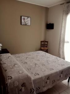 Un dormitorio con una cama con una manta. en B&b De Mauro, en Sava