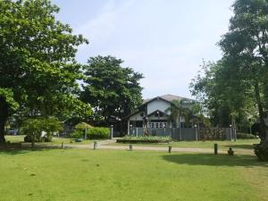 a house in the middle of a park at Buasawan Resort & Restaurant in Kanchanaburi City