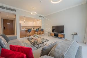 a living room with a couch and a table at KeyHost - Large 1BR Apartment near Five Hotel JVC - Dubai - K310 in Dubai