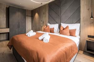 a bedroom with a large bed with towels on it at Panorama Nature Lodge in Hart im Zillertal