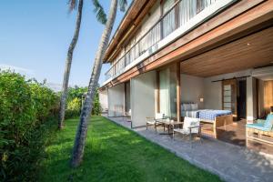 a guest house with a bedroom and a garden at MASMARA Resort Canggu in Canggu