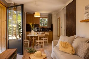 a living room with a couch and a table at Domaine du Ferret Restaurant & Spa in Cap-Ferret