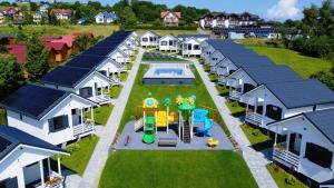 an aerial view of a row of houses with a playground at Domki M&L in Polańczyk