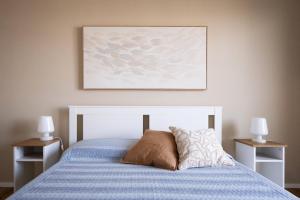 Uma cama ou camas num quarto em Appartamento Nautilus