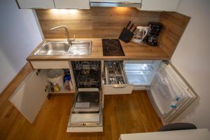 an overhead view of a small kitchen with a sink at Modern Innsbruck Apartment I Free Parking in Innsbruck