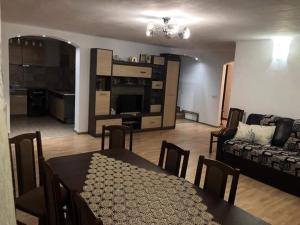 a living room with a table and a couch at Casa Rares Toc in Vidra
