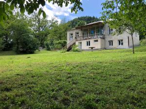 a house on a hill with a field in front of it at Authentic house with a huge garden in Utsera
