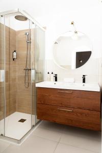 a bathroom with a sink and a shower with a mirror at Villa Veaco Beach with jacuzzi and private pool in Corralejo