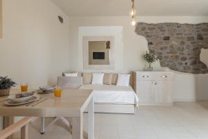 a bedroom with a bed and a table with drinks on it at Marousas Place in Agkidia