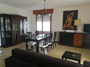 a living room with a table and chairs and a couch at Lucia1 in Silvi Marina