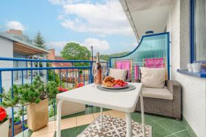 a balcony with a table with fruit on it at Your Holidays Pomorska in Międzyzdroje