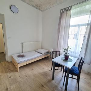 1 dormitorio con 1 cama, mesa y sillas en Apartment Porta en Terezín