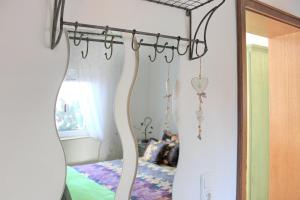 a mirror in front of a bedroom with a bed at Ferienwohnung Sommerwiese in Lübbenau +23 photos