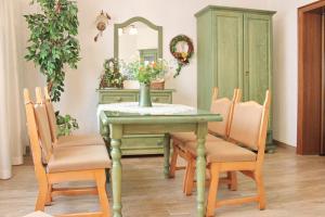 a dining room table with chairs and a mirror at Ferienwohnung Sommerwiese in Lübbenau