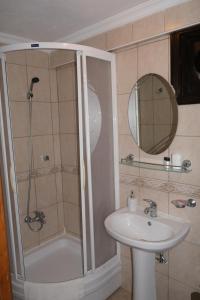 a bathroom with a shower and a sink at Uzum Hotel in Bozcaada