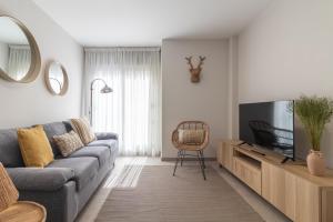 Televízia a/alebo spoločenská miestnosť v ubytovaní Apartamento Chacolina Las Canteras