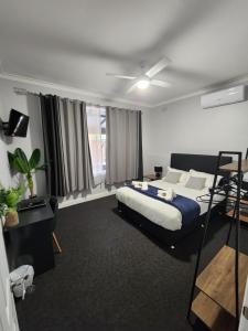 a bedroom with a bed and a ceiling fan at Royal Hotel Sea Lake in Sea Lake