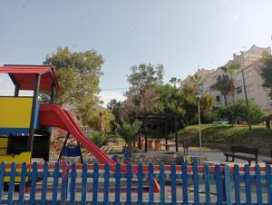 a playground with a slide in a park at Balcón al mar in Adra