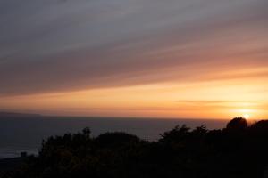 a sunset with the ocean in the background at Chalet Saunton in Braunton