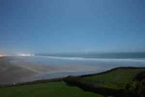 a view of a beach with a fence and the ocean at Chalet Saunton in Braunton