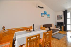 a living room with a table and a couch at Apartment Senada 1503 in Galižana