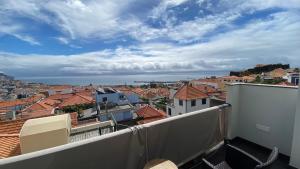 a view of a city from a balcony at Casa dos Arrifes in Funchal +58 photos