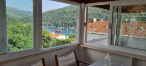 a room with a window with a view of a river at BaLoRo apartment in Mokošica