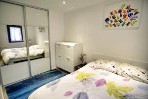 a bedroom with a bed and a mirror at Ref EGEE - Palmes d'Or Properties in Cannes