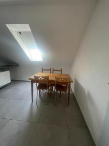 a dining room table with two chairs and a skylight at Joanna Apartment - MA City 2 in Mannheim