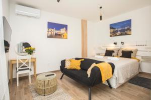 a bedroom with a bed and a couch at Studio and hot tub in Split