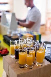 un montón de vasos de jugo de naranja en una mesa en LyvInn Hotel Frankfurt Messe en Frankfurt