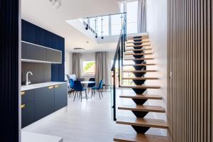 a staircase in a kitchen next to a dining room at Art Boulevard in Mrzeżyno