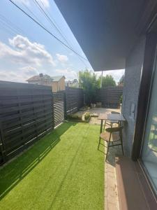 a small backyard with a table and a lawn at Premium Terrace Apartament in Krakow