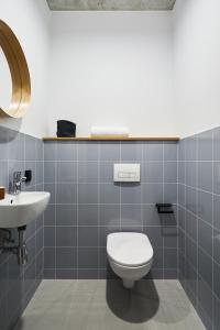 a bathroom with a toilet and a sink at Chill Inn in Łódź