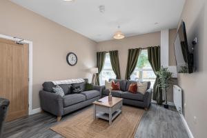 a living room with a couch and a table at Finest Retreats - Peace Retreats Apartment, Pwllheli in Pwllheli