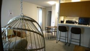a bird cage is hanging in a living room at Blue Lagoon near Apple in Santa Clara