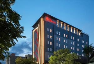 a hotel with a sign on the side of it at ibis Surabaya Tidar in Surabaya