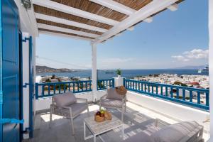 a balcony with chairs and a view of the ocean at Marisso Hotel in Mikonos