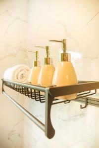 a bathroom shelf with three toothbrushes on it at An Sunrise Villa Vinh Phuc in Vĩnh Phúc