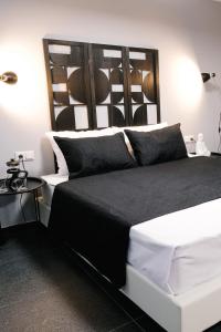 a bedroom with a large black and white bed at Venizelou Comfort & Living II in Kavala
