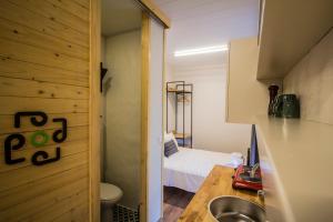 a bathroom with a sink and a bed in a room at podbodrum tiny house in Bodrum City