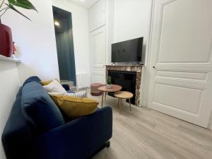 a living room with a blue couch and a fireplace at Luxury Apartment "Le Raffiné" - Lyon Part-Dieu - Dreamy Flat Lyon in Lyon