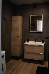 a bathroom with a sink and a mirror at Turkusowe tarasy apartament in Czeladź