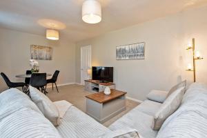 a living room with a couch and a table at Broome Road in Durham