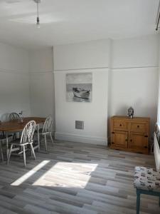 a dining room with a table and a table and chairs at Flat Beside the sea in Southend-on-Sea