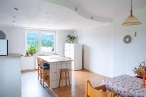 a kitchen with a white refrigerator and a table at Noclegi U Fela in Ustrzyki Dolne