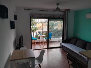 a living room with a couch and a table with chairs at apartamento vista al mar piscina playa 3 min in Aguadulce