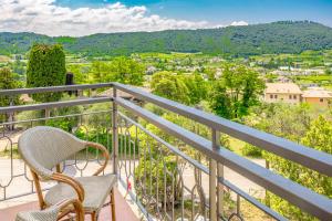 a balcony with chairs and a view of a city at Residenza Panorama in Costermano